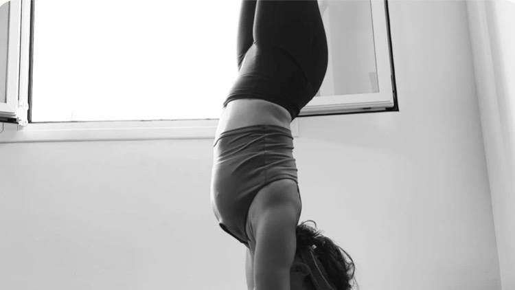 A handstand practised beside a bright window